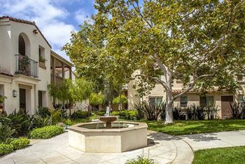 a fountain sits in the middle of a courtyard at The Villas at Anacapa Canyon, Camarillo, CA, 93012